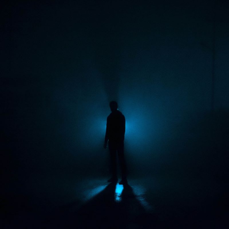 Shadow figure illuminated by blue light